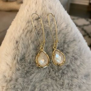 Kendra Scott gold and mother of pearl earrings.